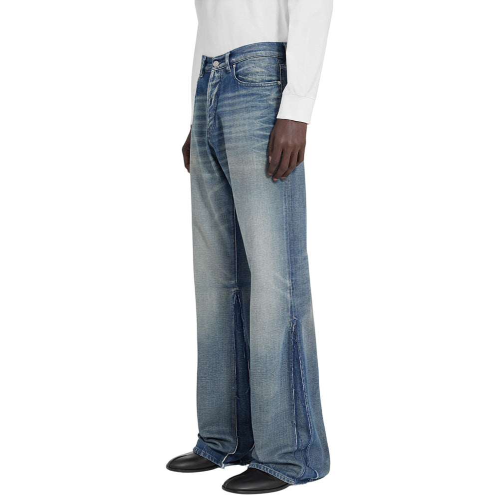 Person wearing blue jeans on a white background