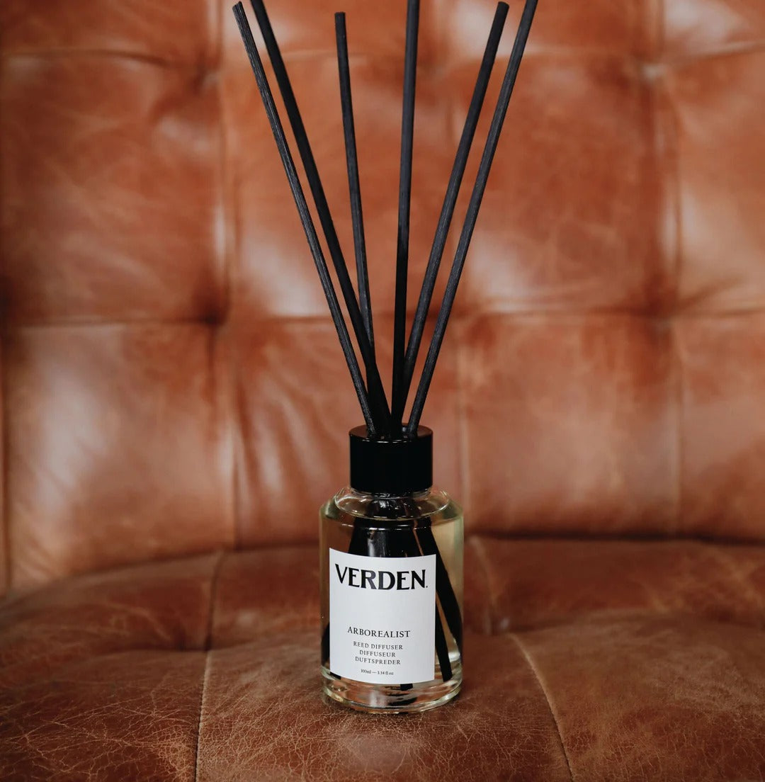Verden diffuser bottle with black reeds on a brown leather surface